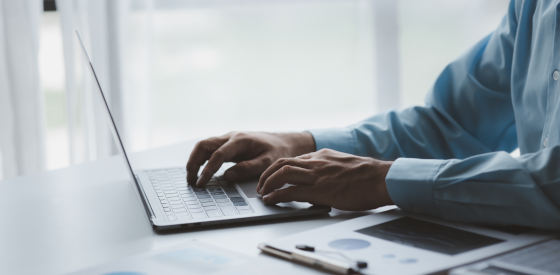 Hands on a laptop typing