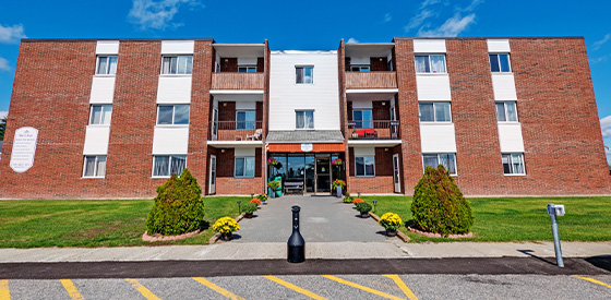 Exterior of an apartment building at 1214 Riverside Drive in Timmins, Ontario.